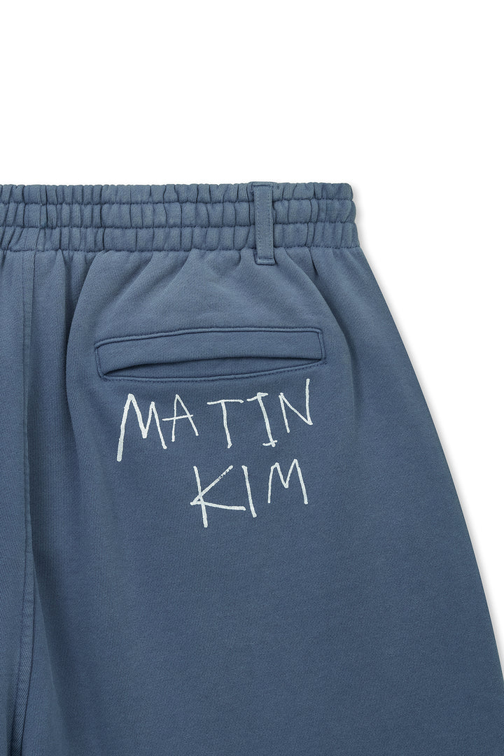 Matin Kim Vintage Washed Back Logo Bermuda Sweatpants — Blue