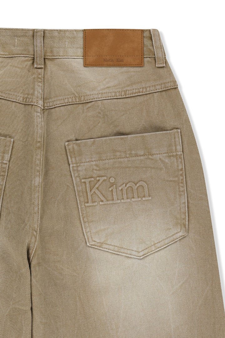 Matin Kim Back Logo Washed Denim Pants — Beige