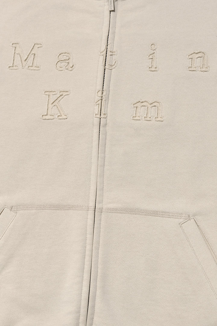 Matin Kim Appliqué Cutout Logo Zip Hoodie — Beige