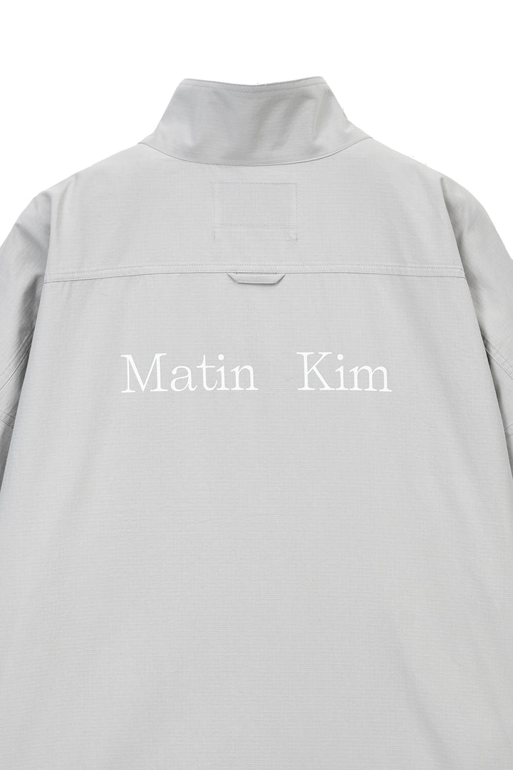 Matin Kim Back Logo High Neck Jumper — Light Grey