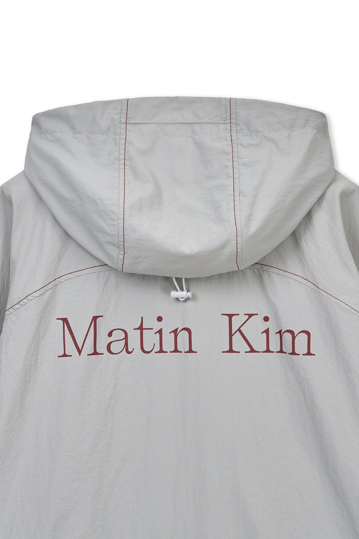 Matin Kim Cropped Back Logo Windbreaker — Beige