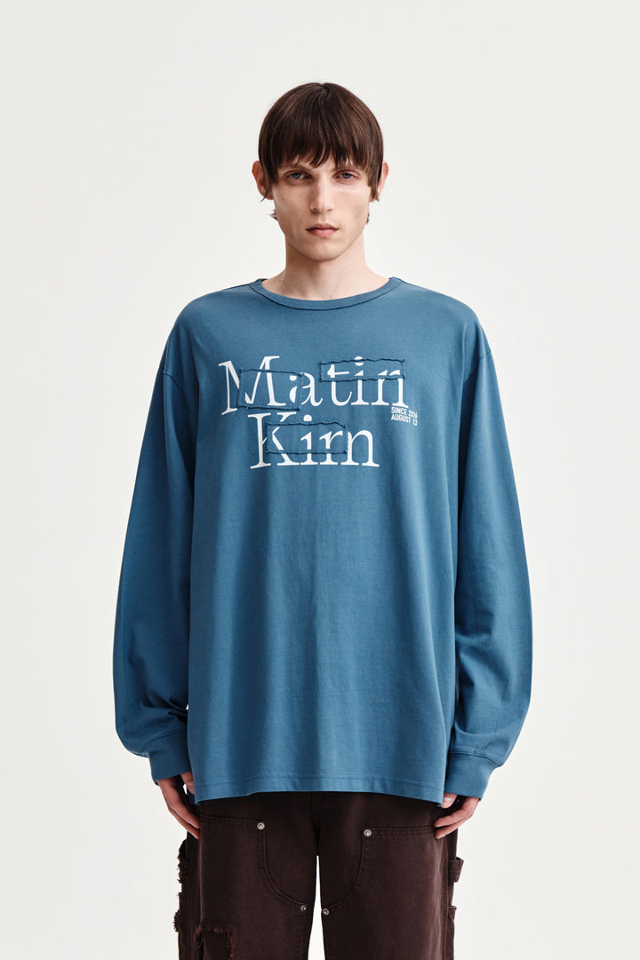 Matin Kim Patch Graphic Long Sleeve Top — Blue