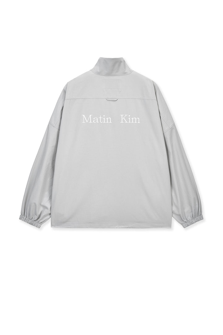 Matin Kim Back Logo High Neck Jumper — Light Grey