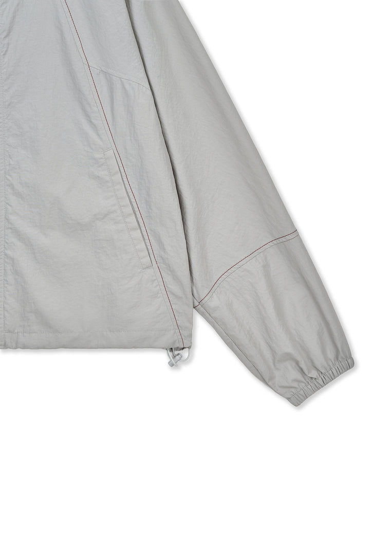 Matin Kim Cropped Back Logo Windbreaker — Beige