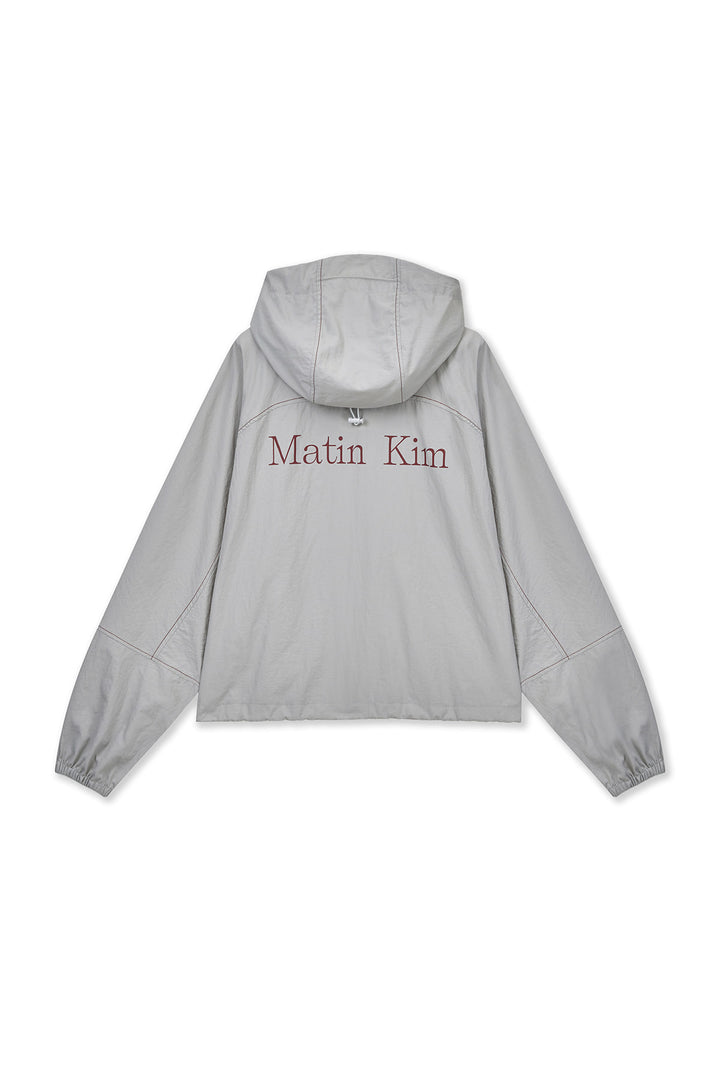 Matin Kim Cropped Back Logo Windbreaker — Beige