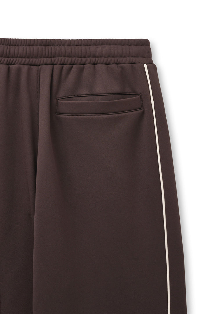 Matin Kim Heart Logo Track Pants — Brown