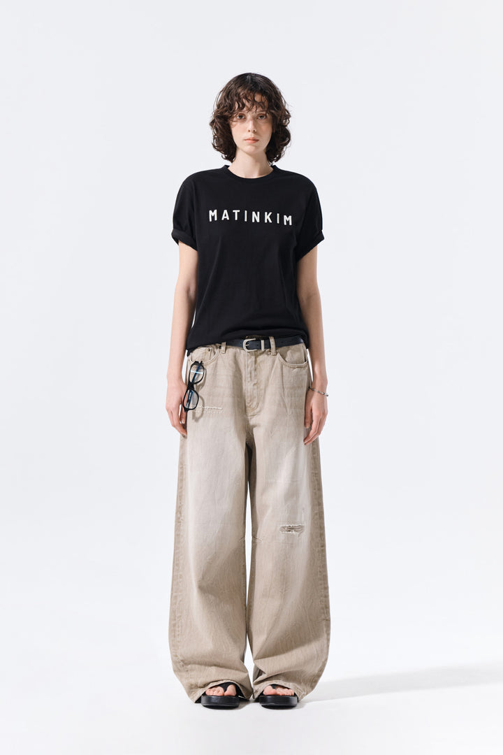 Matin Kim Back Logo Washed Denim Pants — Beige